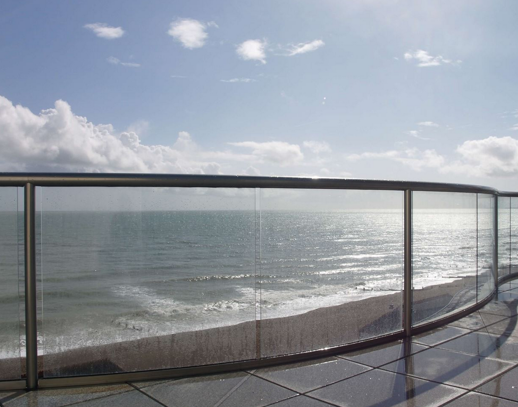 Balconnette Orbit glass balustrade — circular 70mm handrail with minimal posts