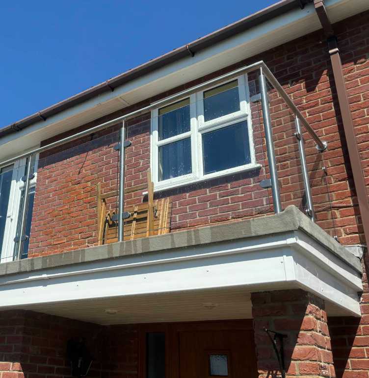 Post and handrail glass balustrade on a steel walk-on balcony