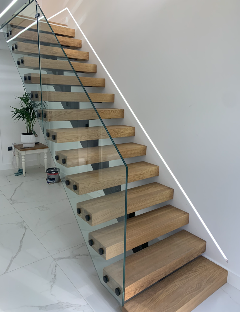 Glass staircase renovation with oak handrail and glass panels