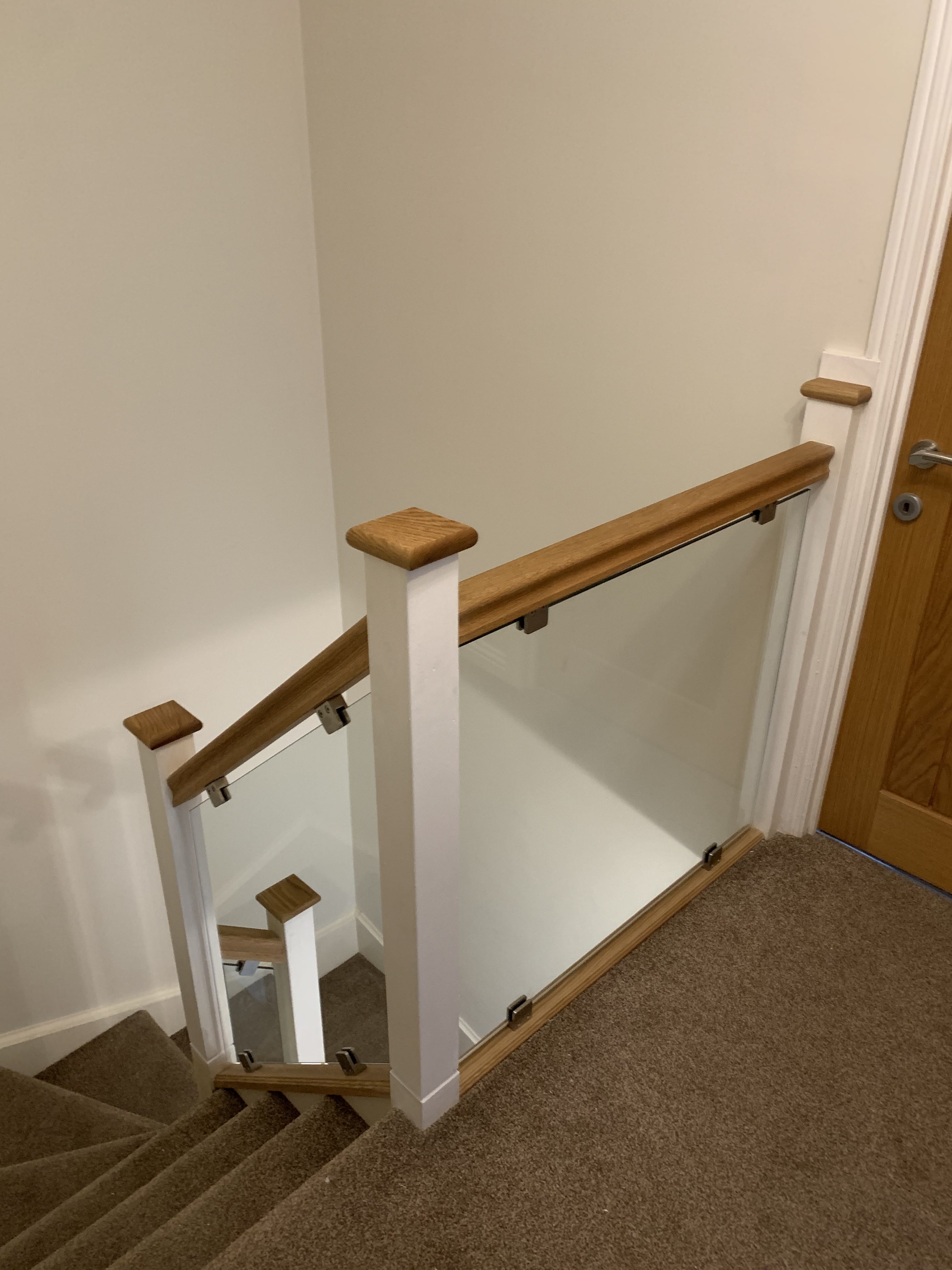 Clamped glass balustrade system on residential staircase — stainless steel clamps