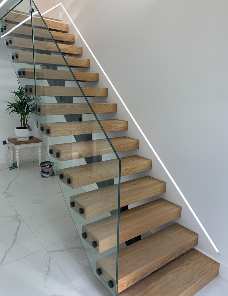 Frameless glass balustrade on floating cantilevered steps with standoff button fixings