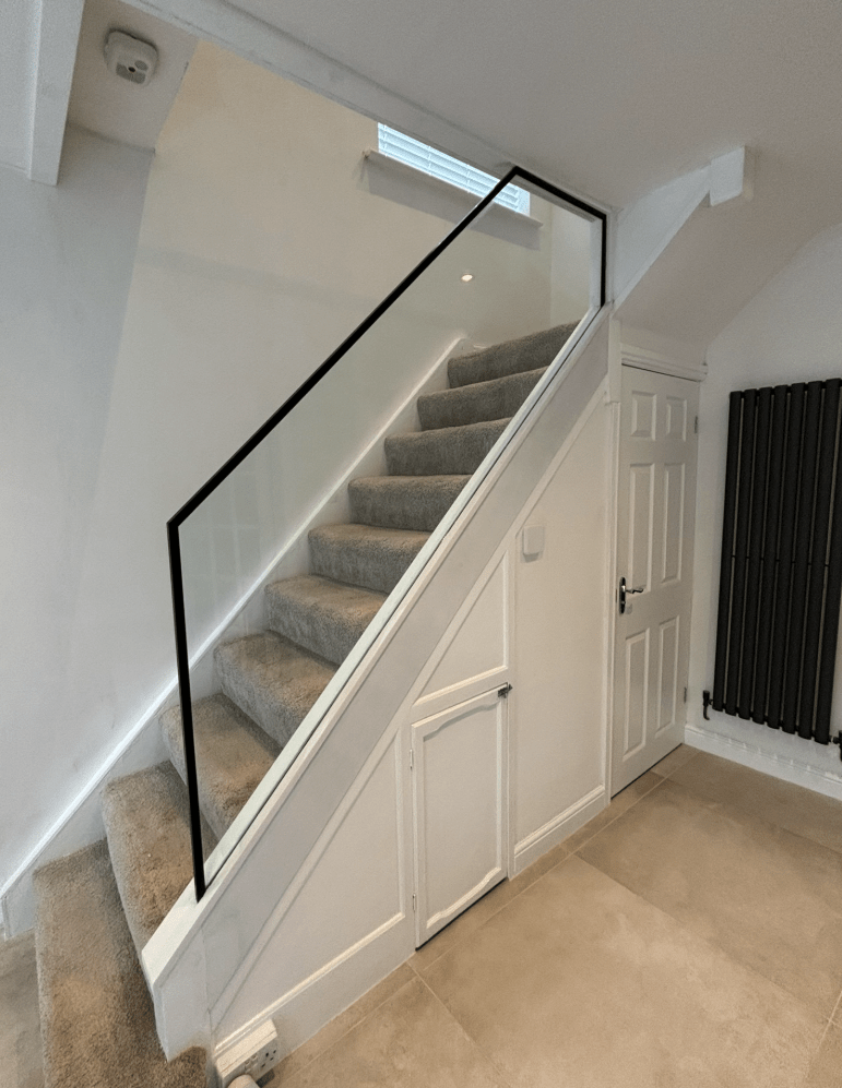 Fully frameless glass staircase with oak treads and glass balustrade panels
