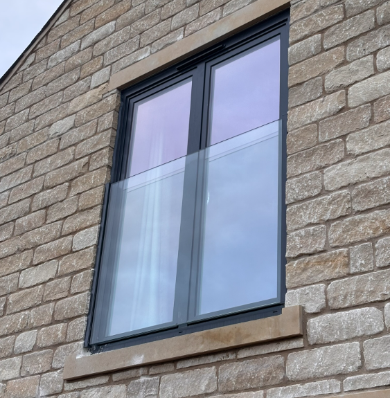 Glass Juliet balcony with slim vertical aluminium rails — Elegance Range
