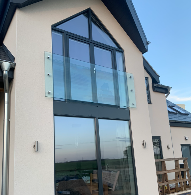 Frameless glass Juliet balcony fixed with stainless steel standoffs