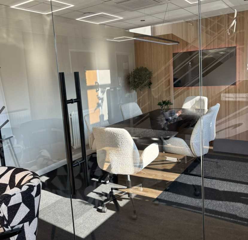 Slimline aluminium-framed glass partition in open-plan office