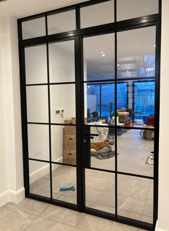 Residential glass divider in open-plan kitchen and dining room