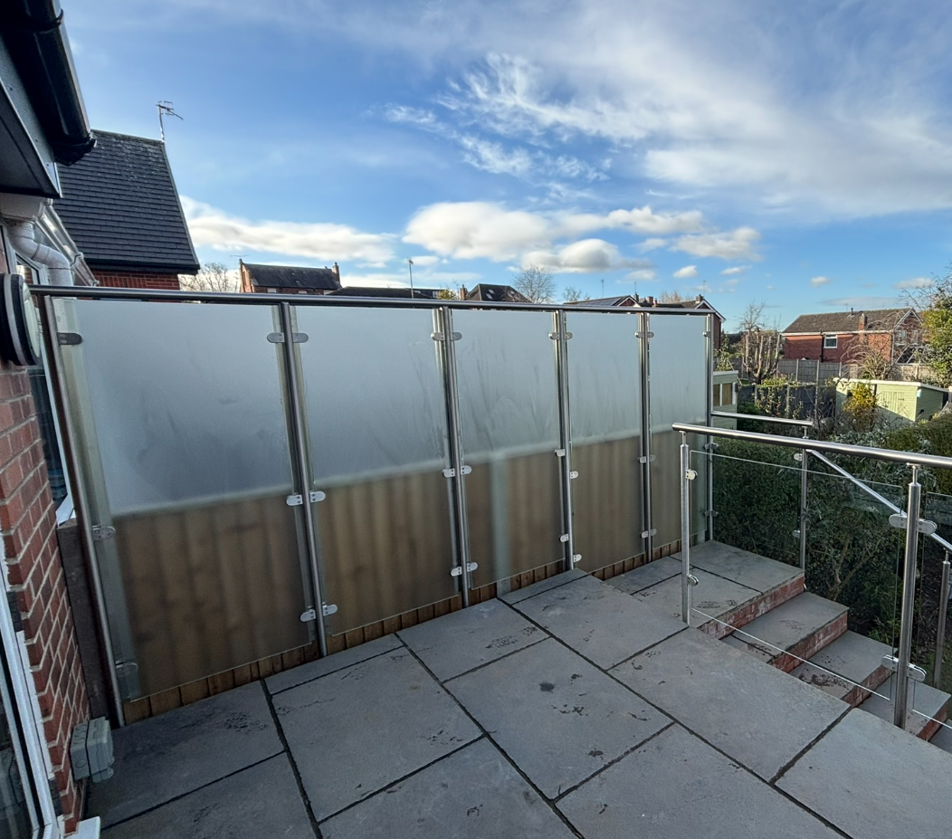 Satin sandblasted glass privacy screen — frameless installation with Ritec coating