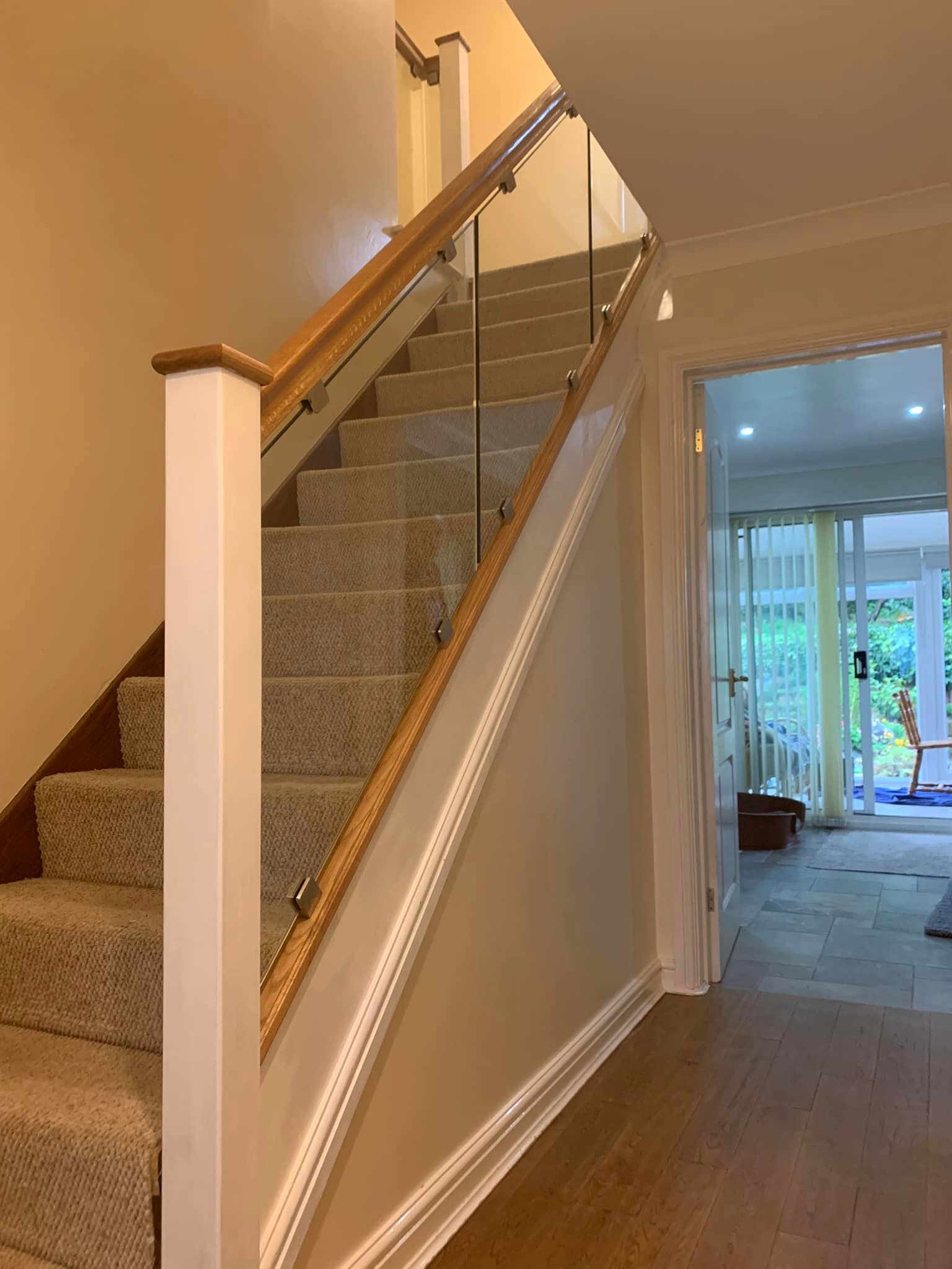White and oak staircase renovation with glass balustrade