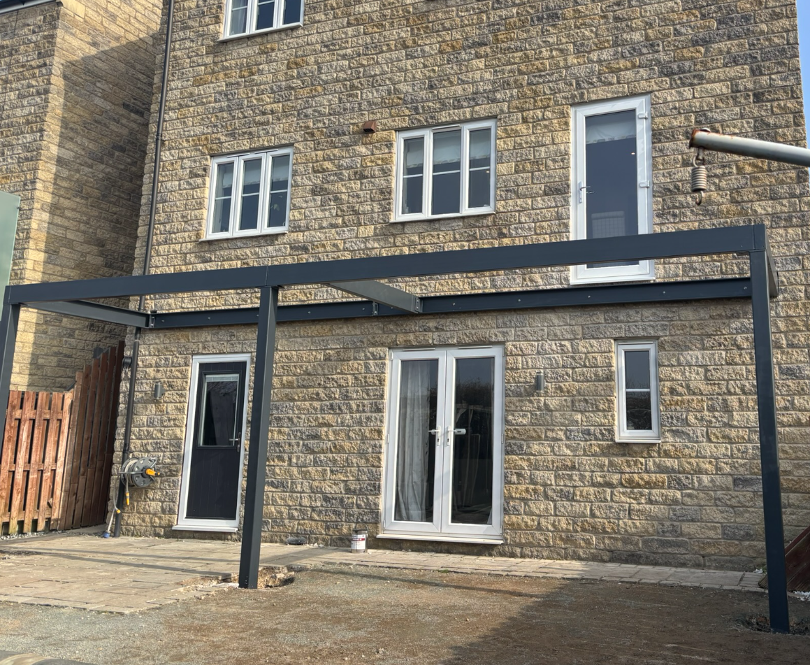 Engineered steel subframe for walk-on balcony