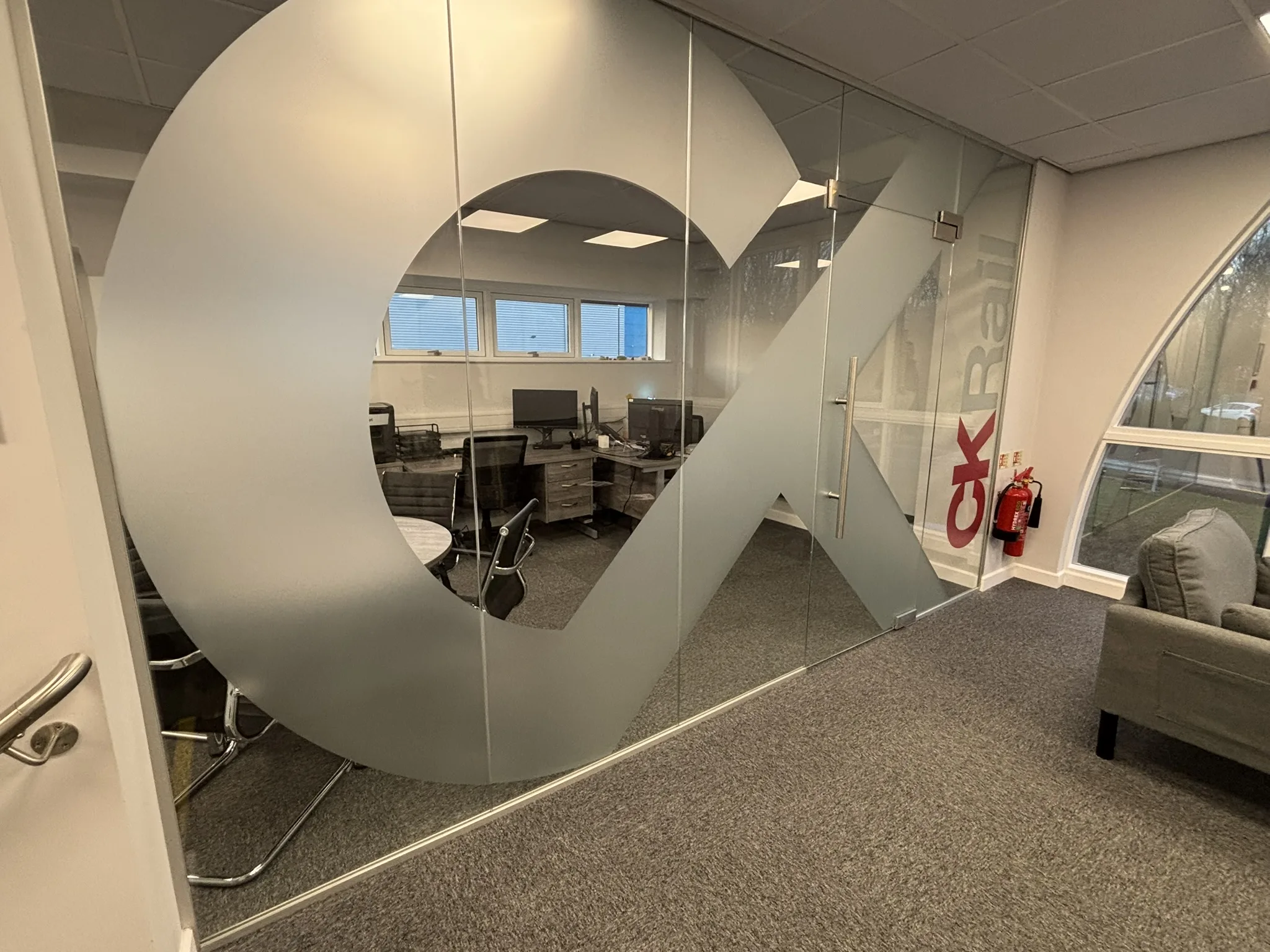 180° pivot glass door in an aluminium partition system in a Chesterfield office.