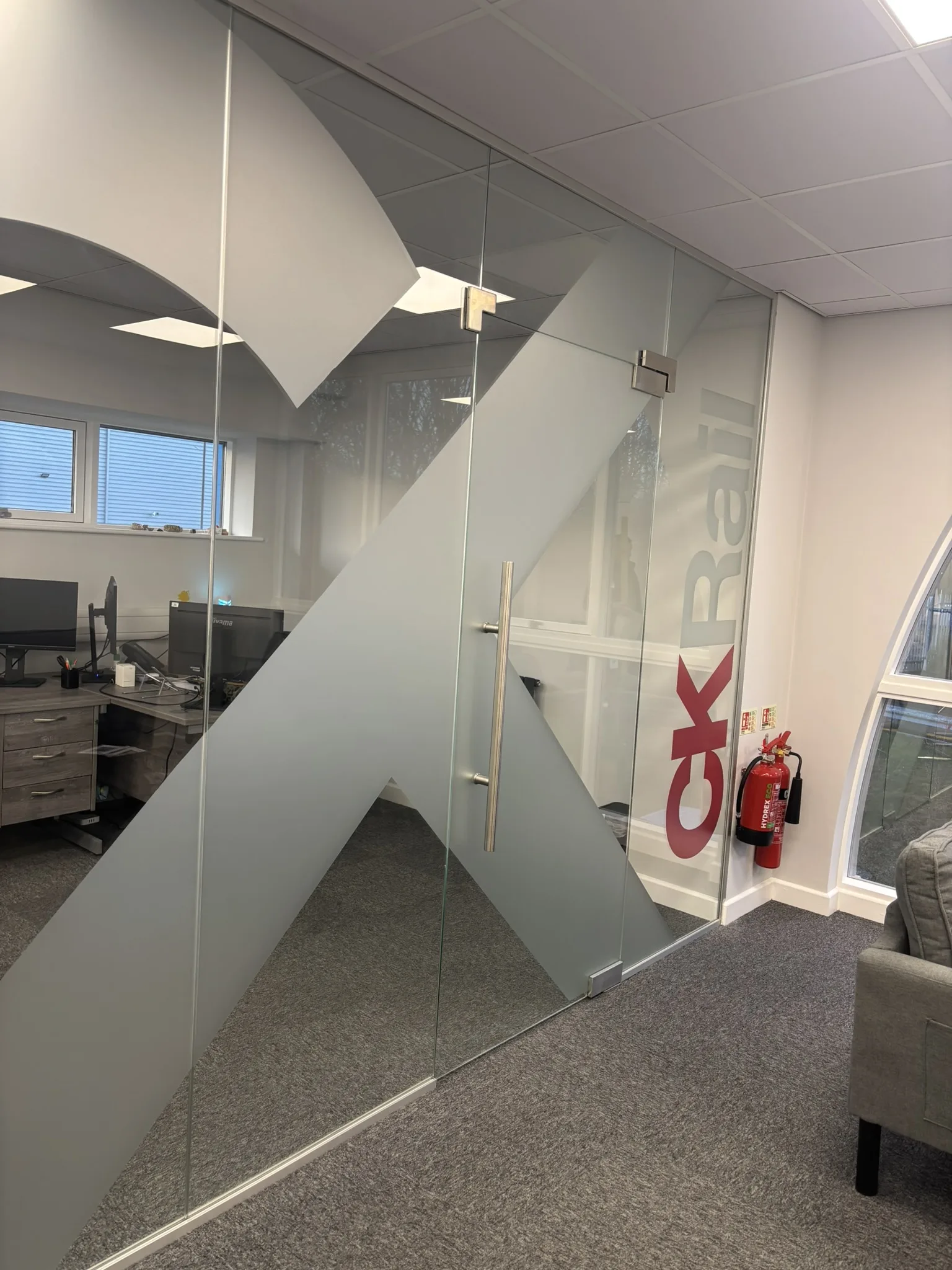 Glass office partition with printed CK Rail logo installed in Chesterfield.