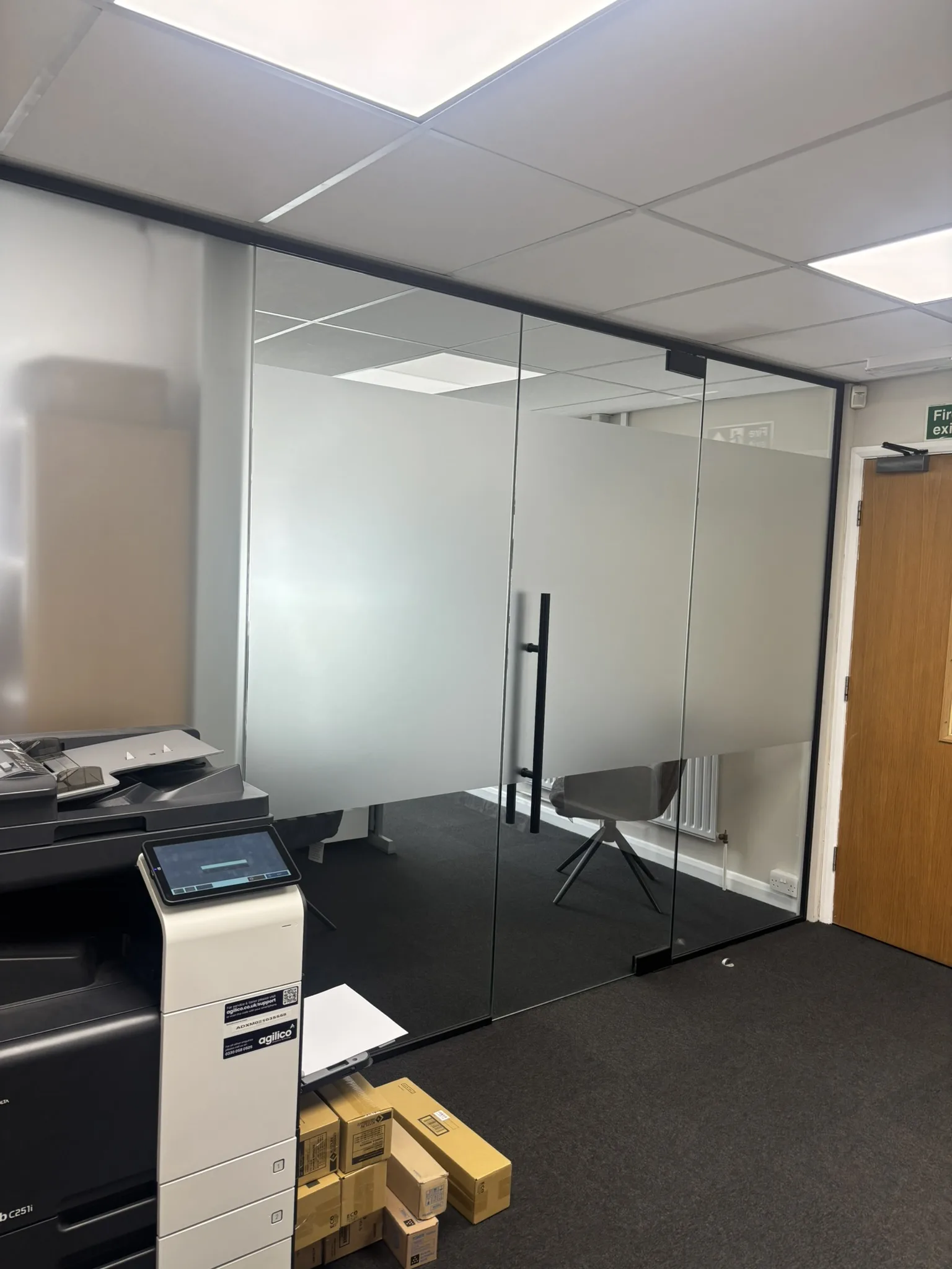 Modern black aluminium framed office partitioning with clear and frosted glass panels