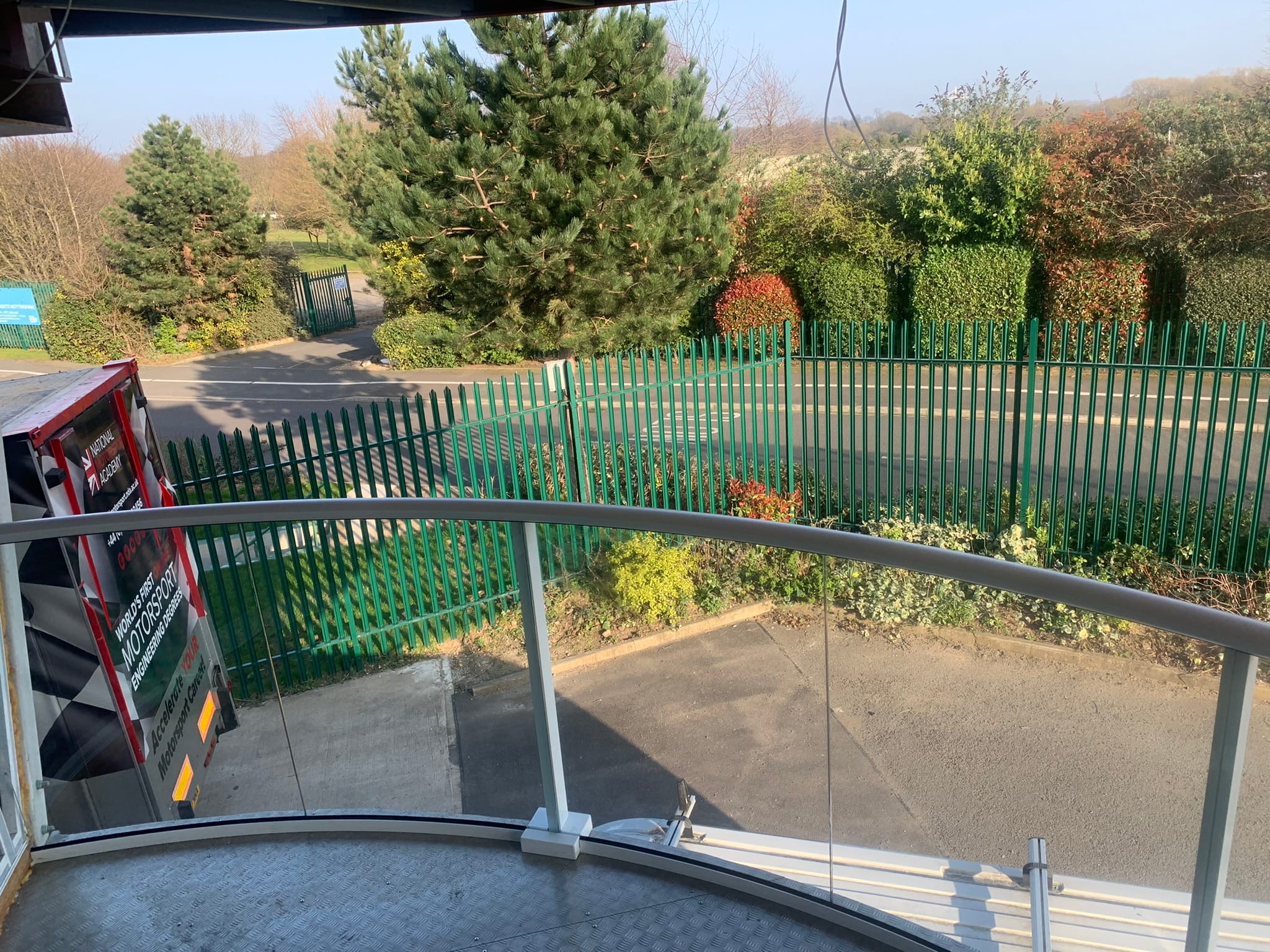 White powder coated Balconnette Aerofoil glass balustrade on curved double balcony, Nottingham