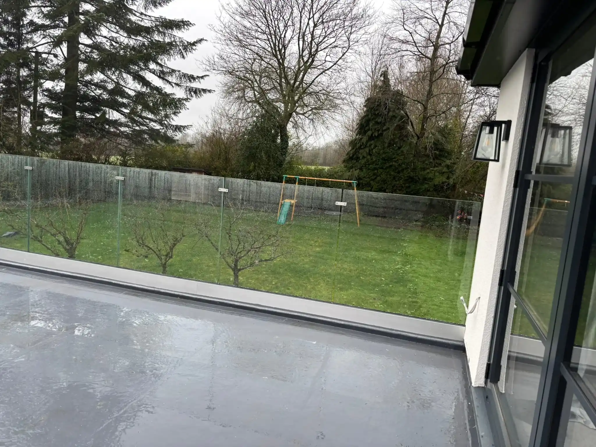 Side view of toughened glass panels in aluminium channel on Doncaster flat roof balcony