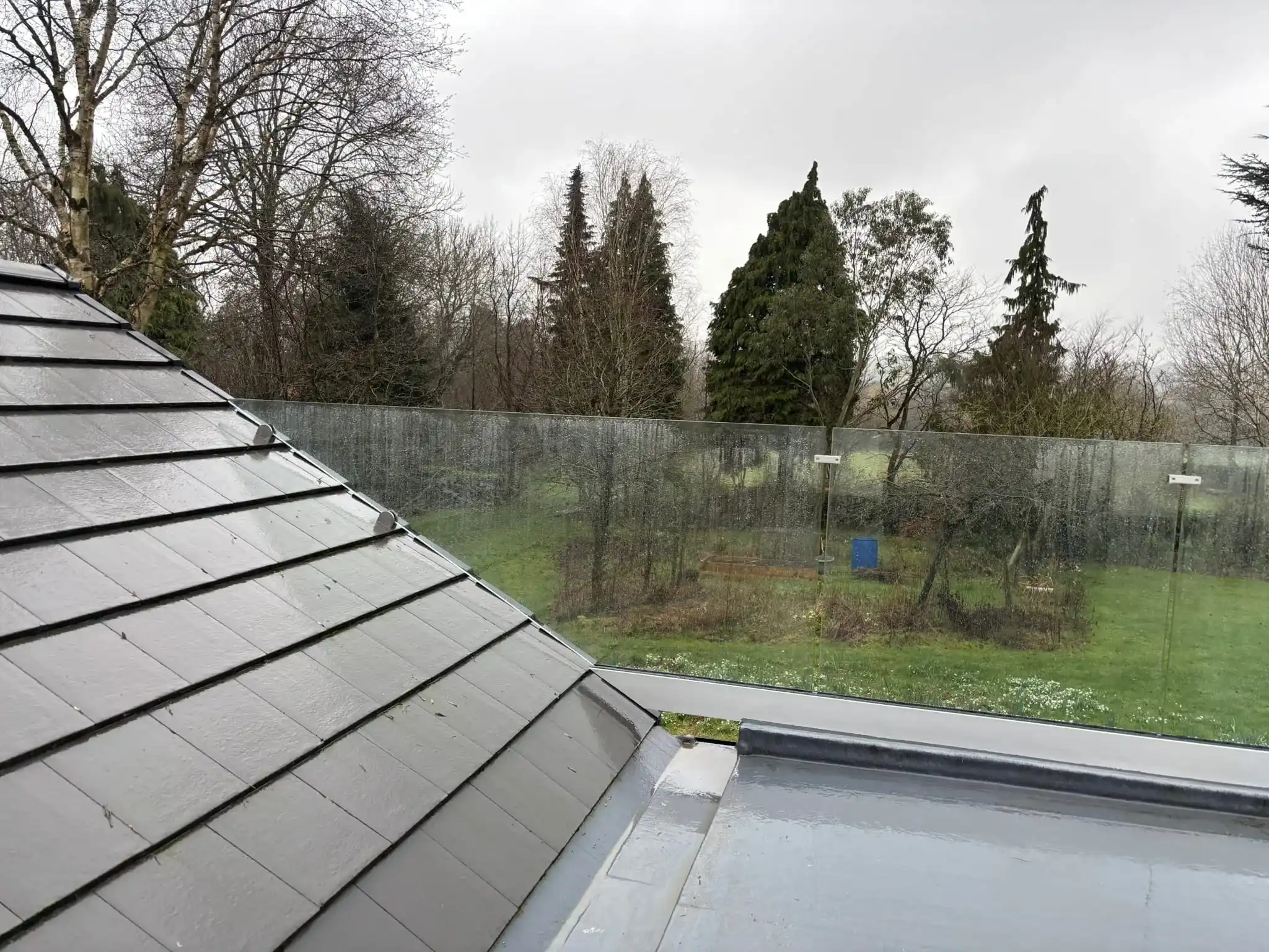 Frameless glass balustrade viewed from bifold door opening onto Doncaster flat roof balcony