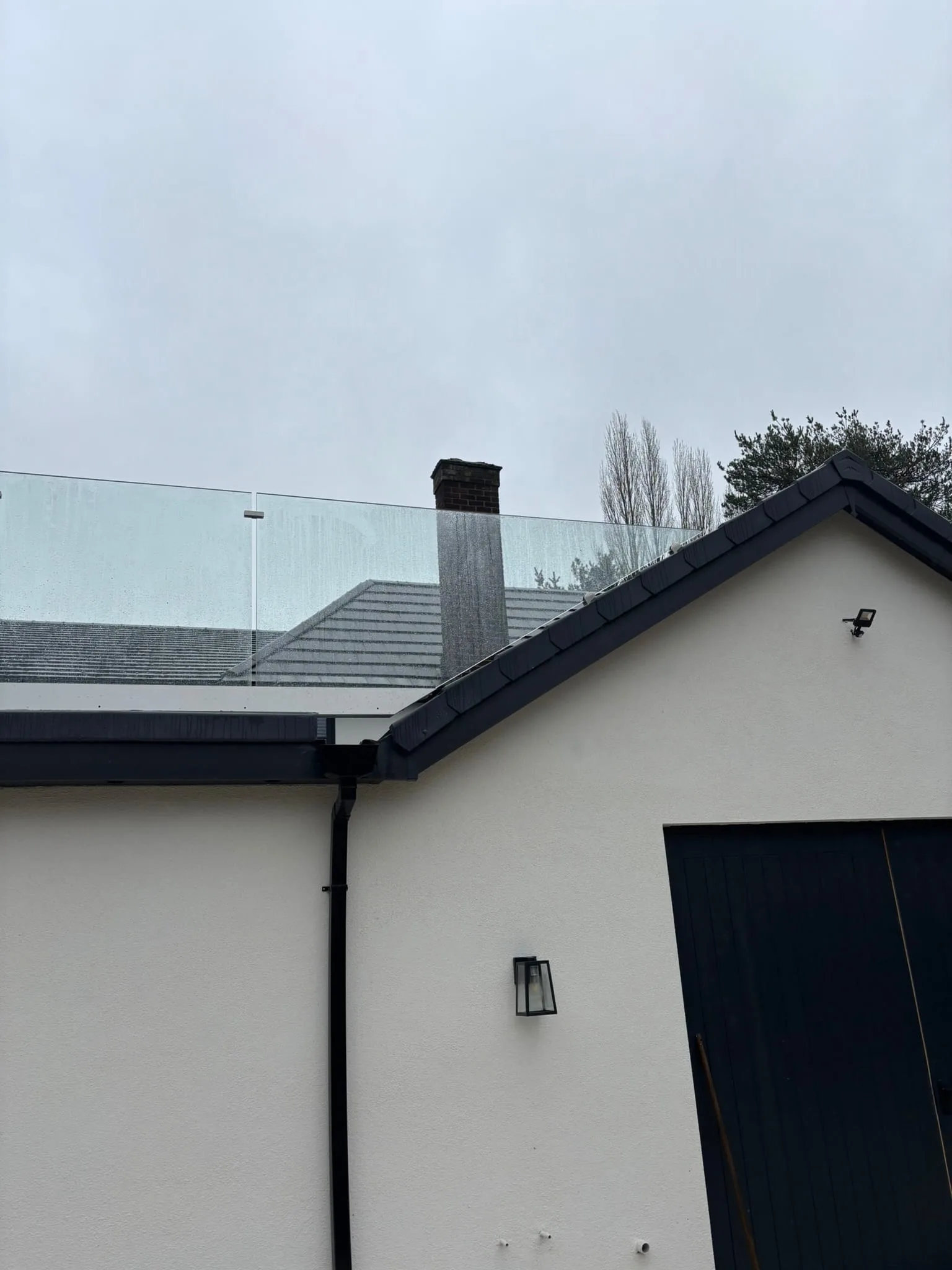 Corner join of frameless channel balustrade with steps and patio visible below, Doncaster
