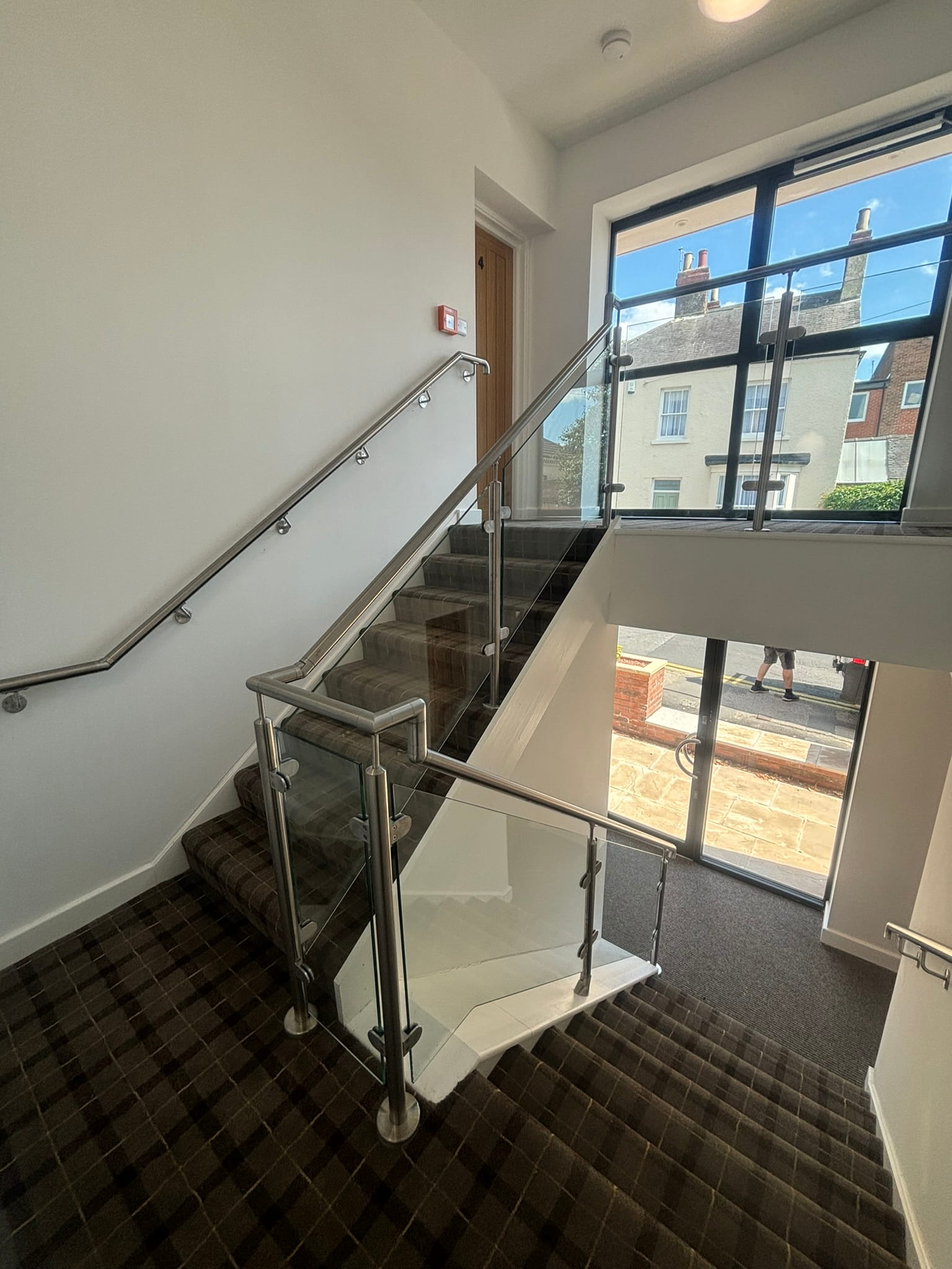 Stainless glass balustrade on HMO staircase at window landing in Rotherham
