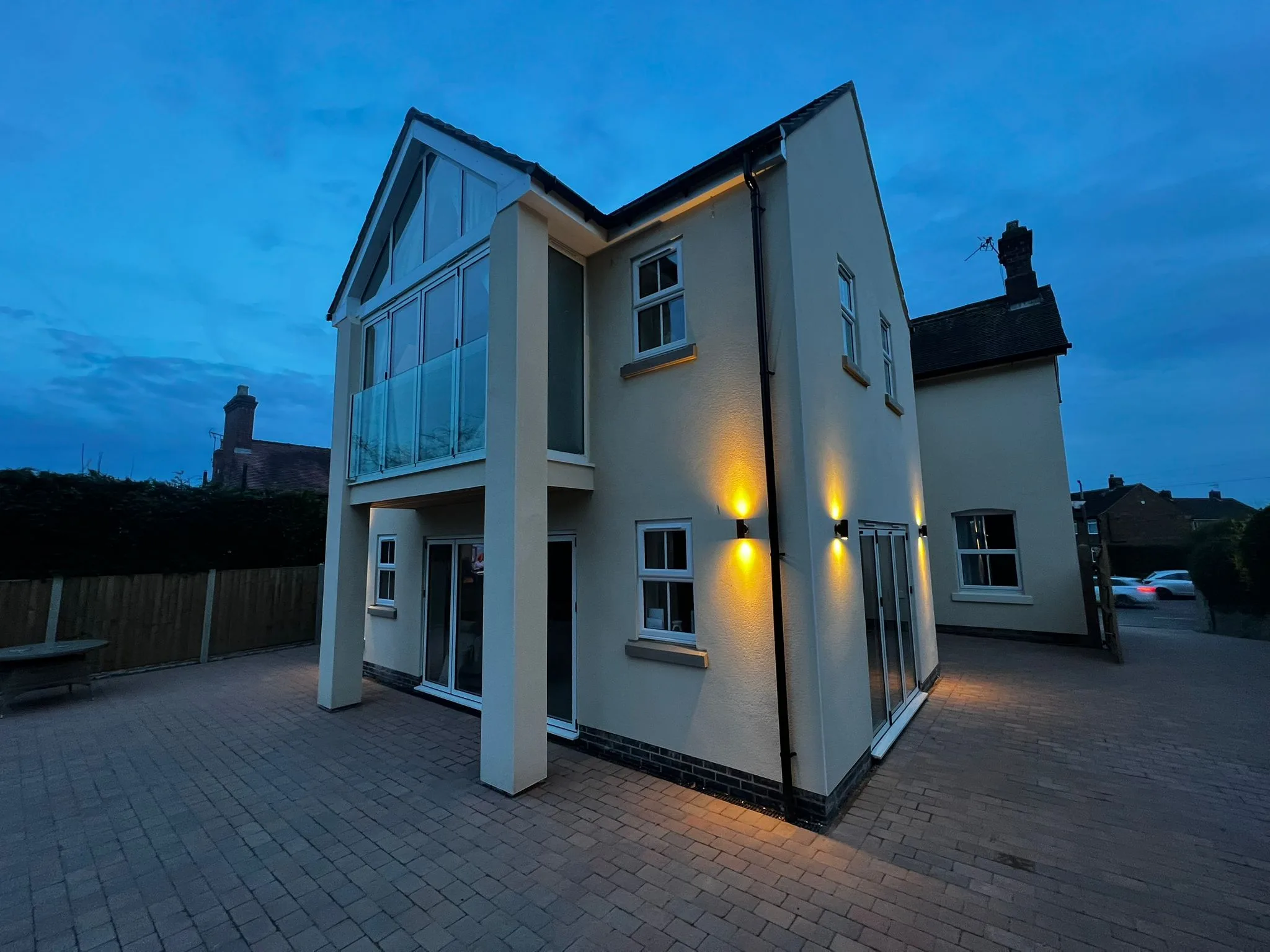 Installation of large glass Juliet balcony using Genie lift and team of fitters in Heanor