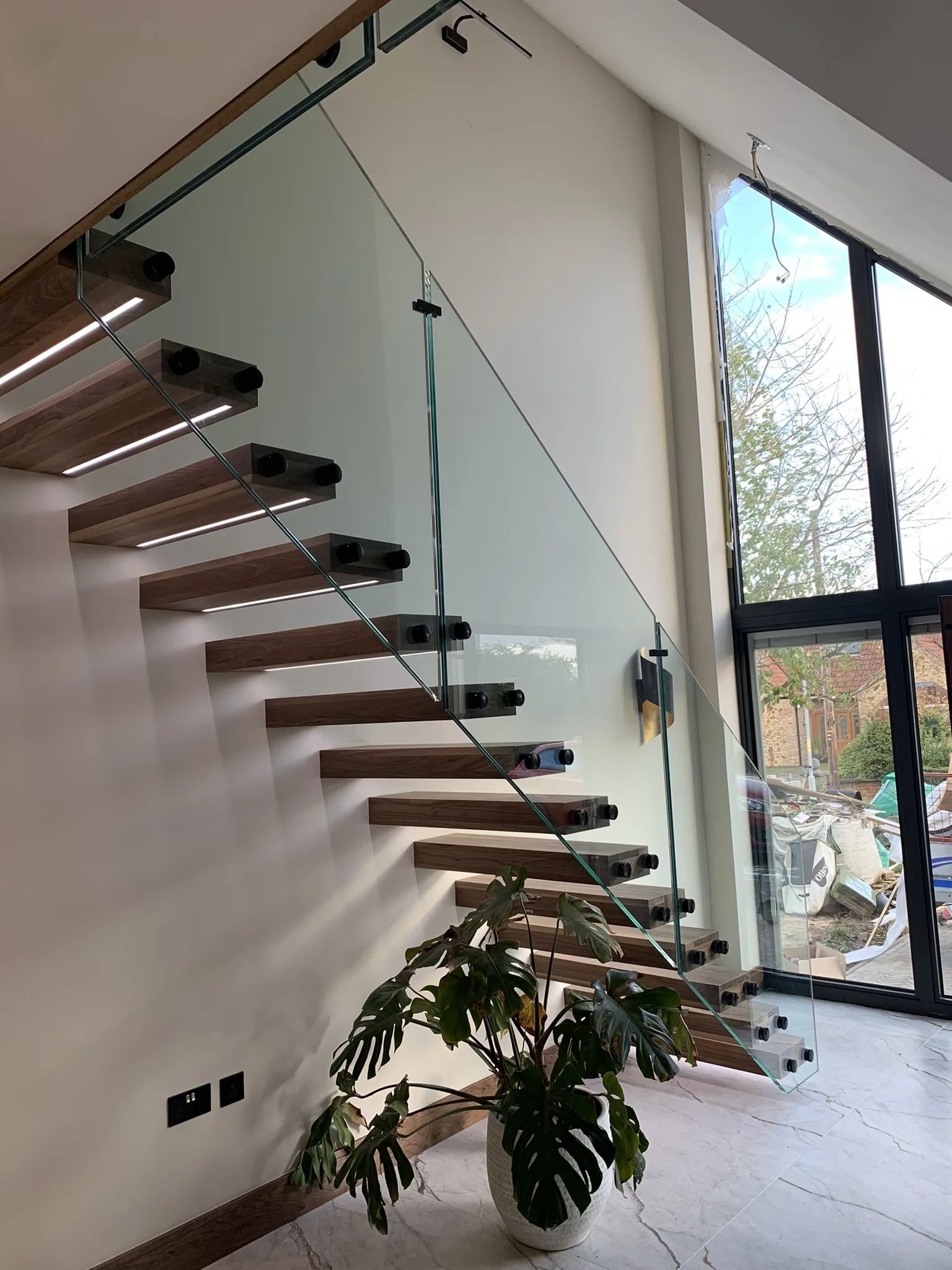 Cantilever floating stairs with internal steel support and glass panels