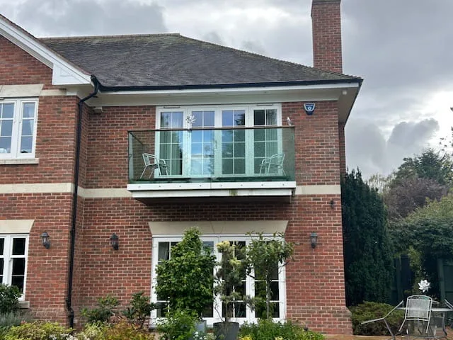 Frameless glass balustrade with aluminium fascia on a large detached property, Nottingham.