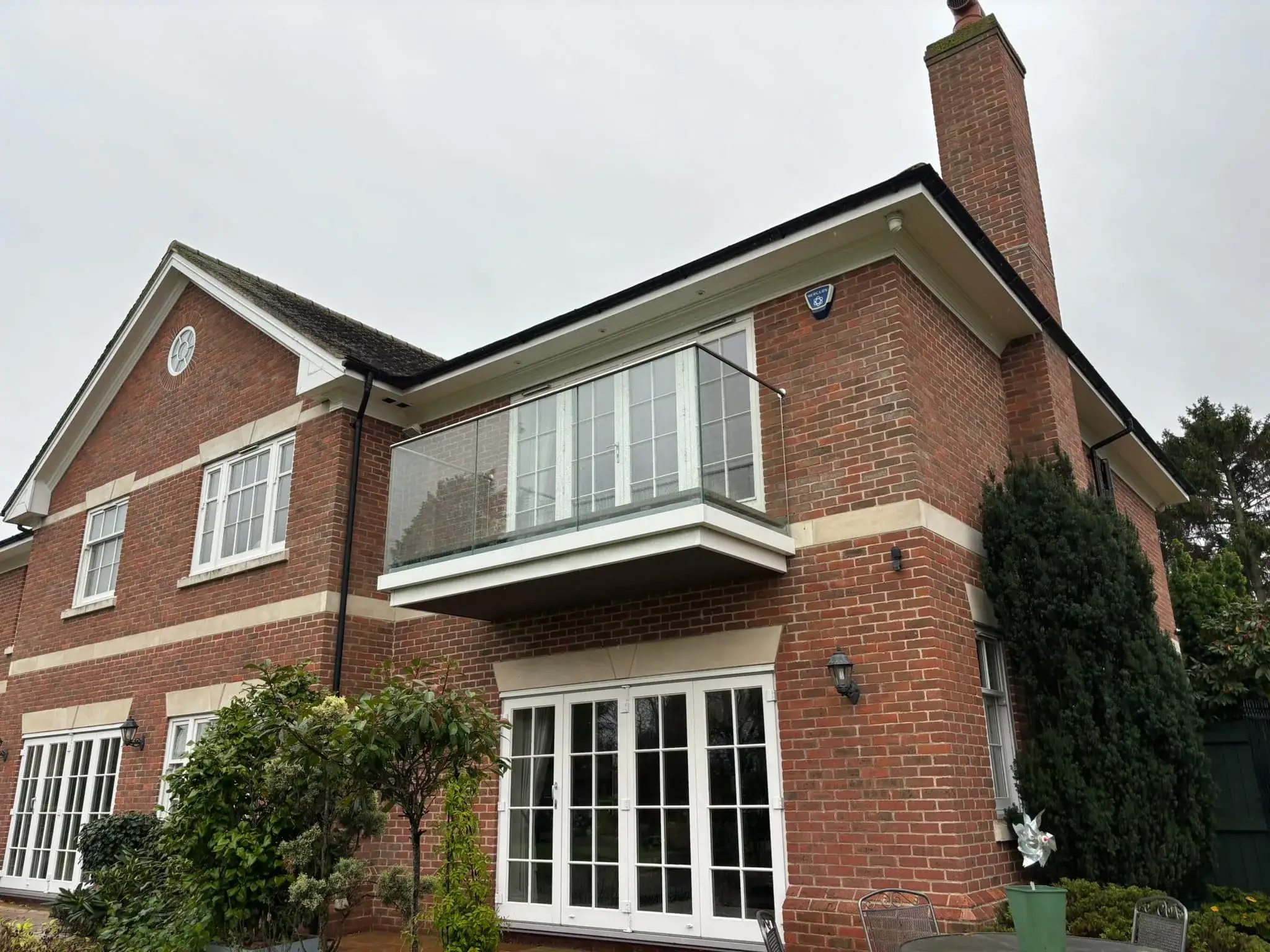 Toughened laminated glass in aluminium base channel on a renovated balcony, Nottingham.