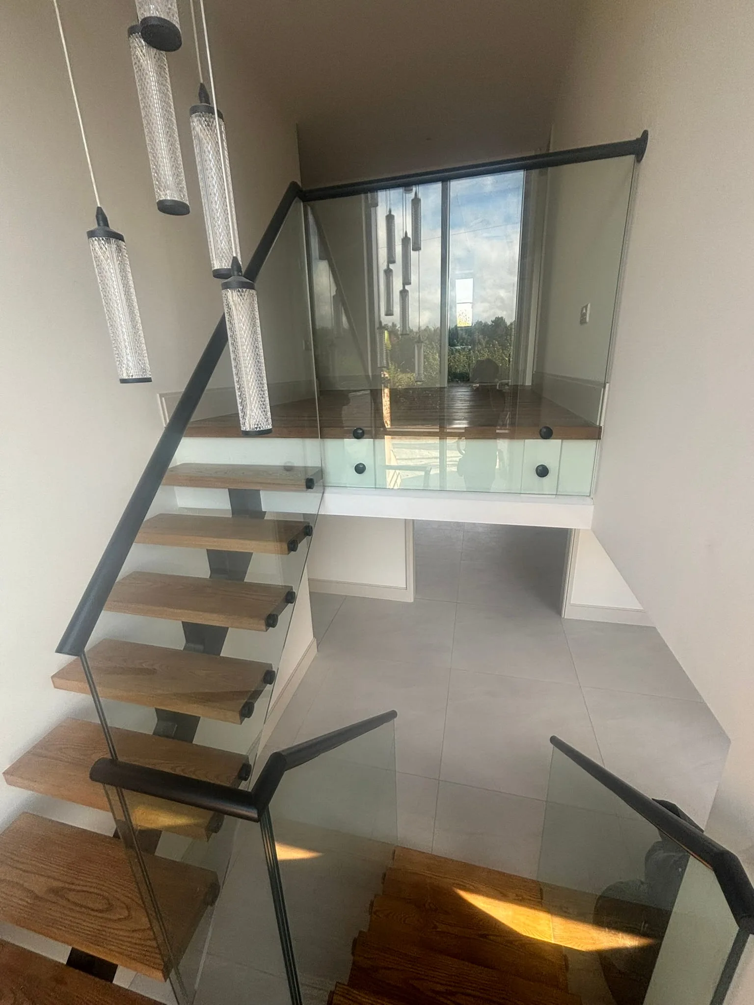 17.5mm laminated glass panels fixed with stainless standoff buttons