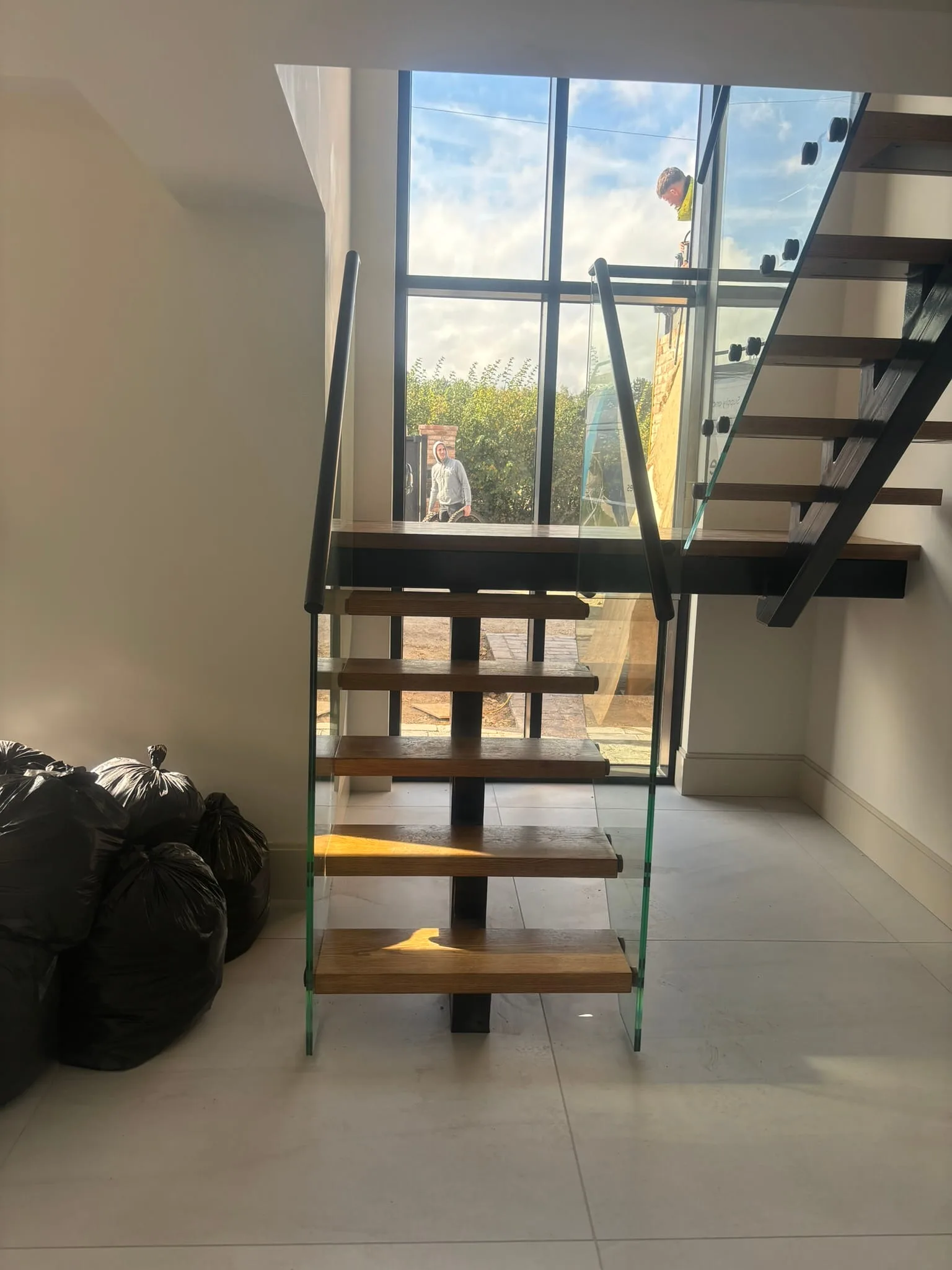 Open oak staircase with modern frameless glass guarding system