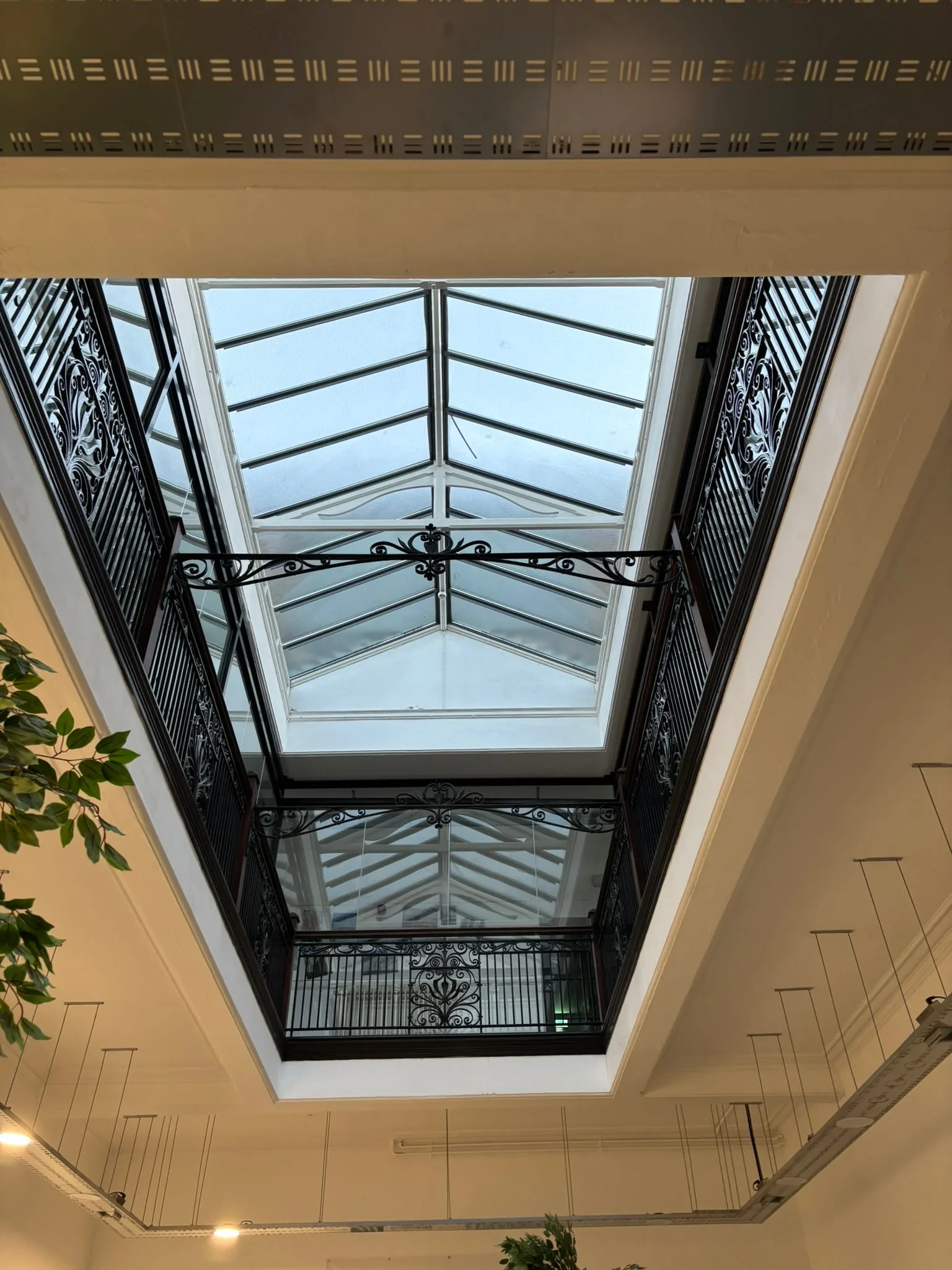 Glass barrier increasing balustrade height in historic building
