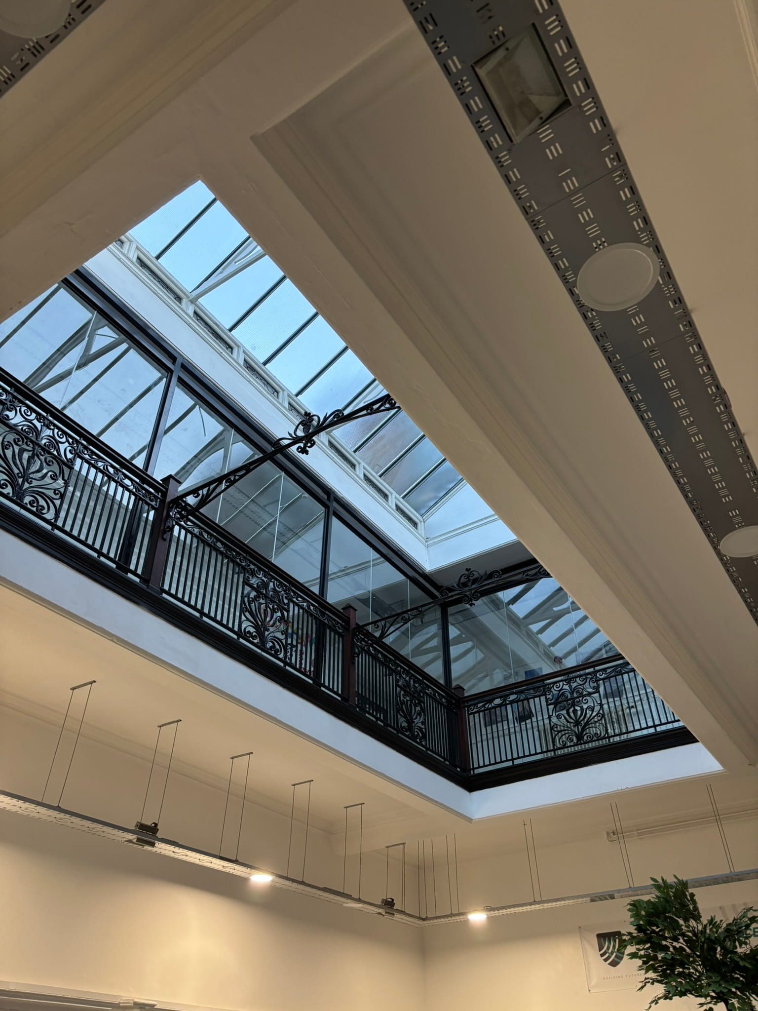 Toughened laminated glass barrier panel — close-up of panel edge and fixing bracket, Burslem School of Art