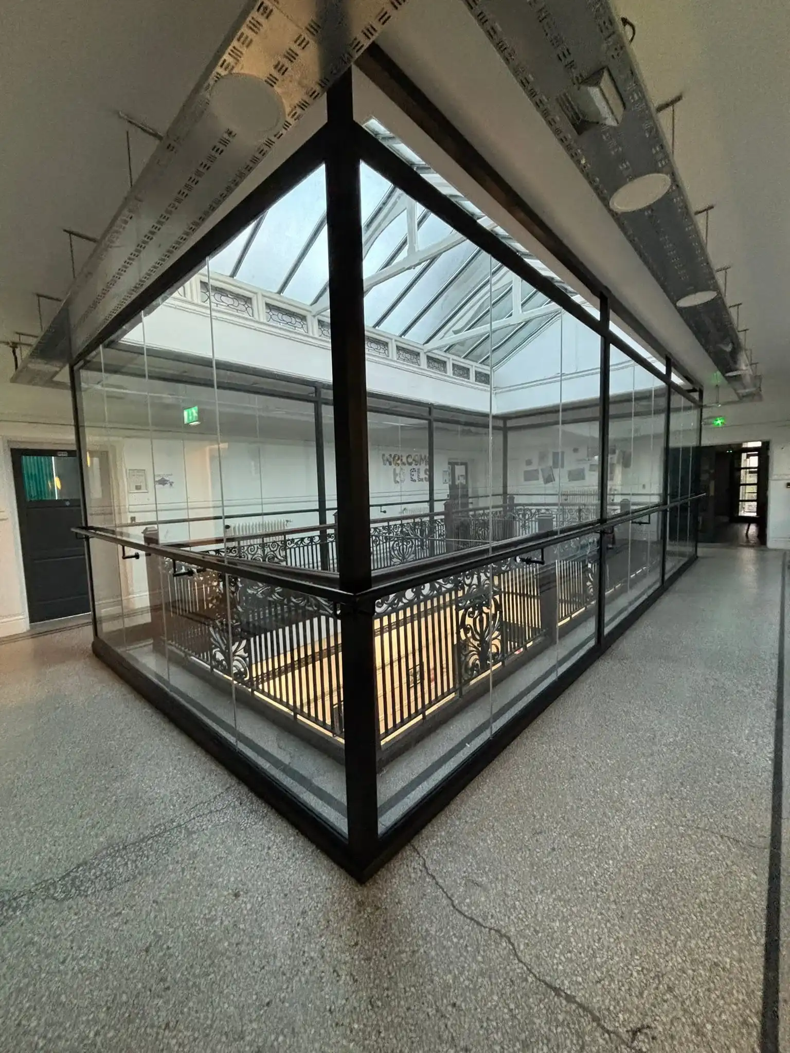 Detail of laminated glass panel fixed to existing balustrade