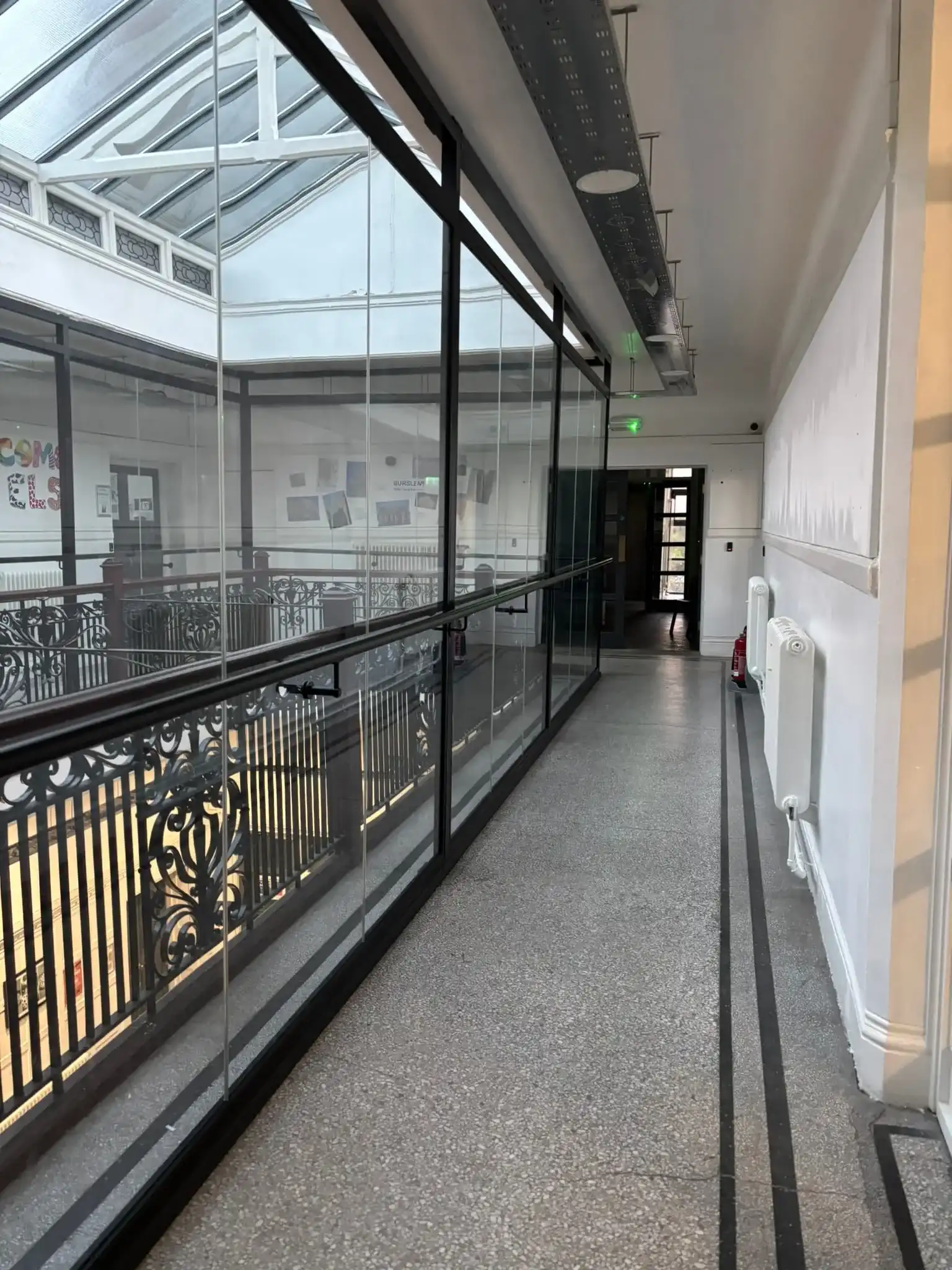 Transparent safety barrier in Victorian school interior