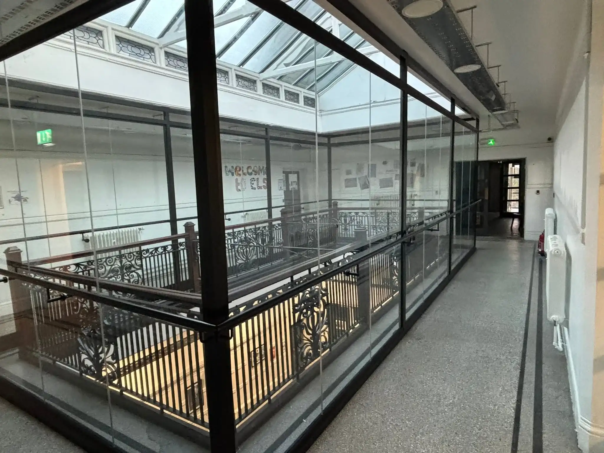 Glass panels aligned along upper level walkway for protection