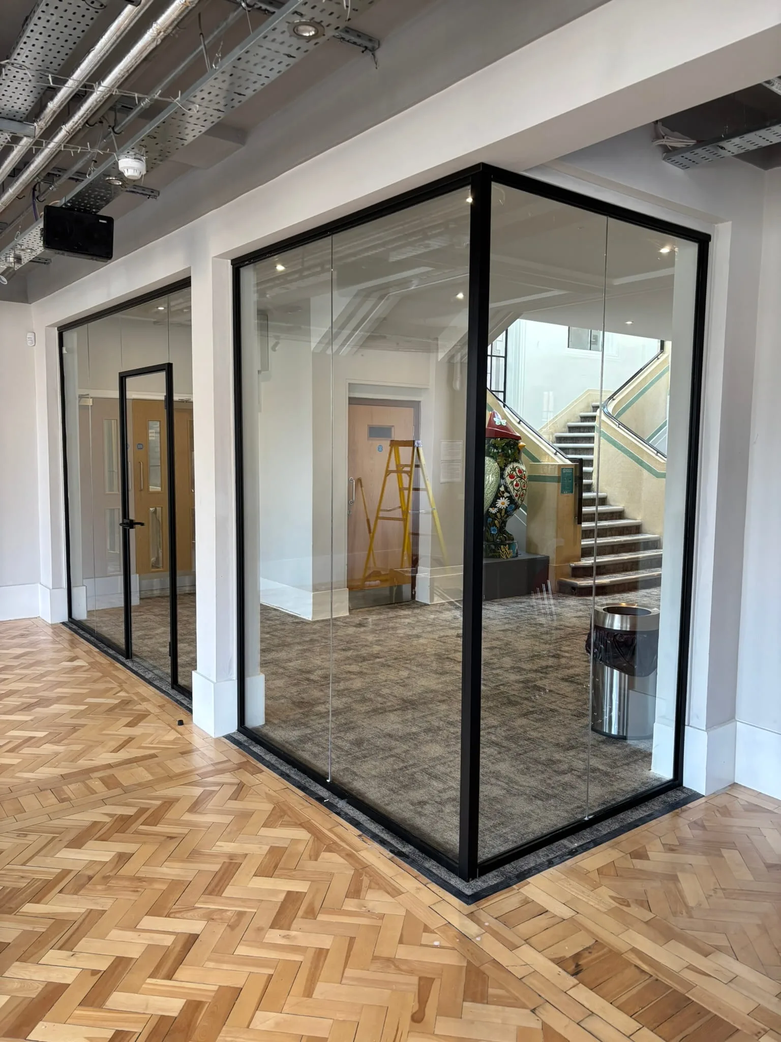 Acoustic glass partition with framed door in Nottingham office