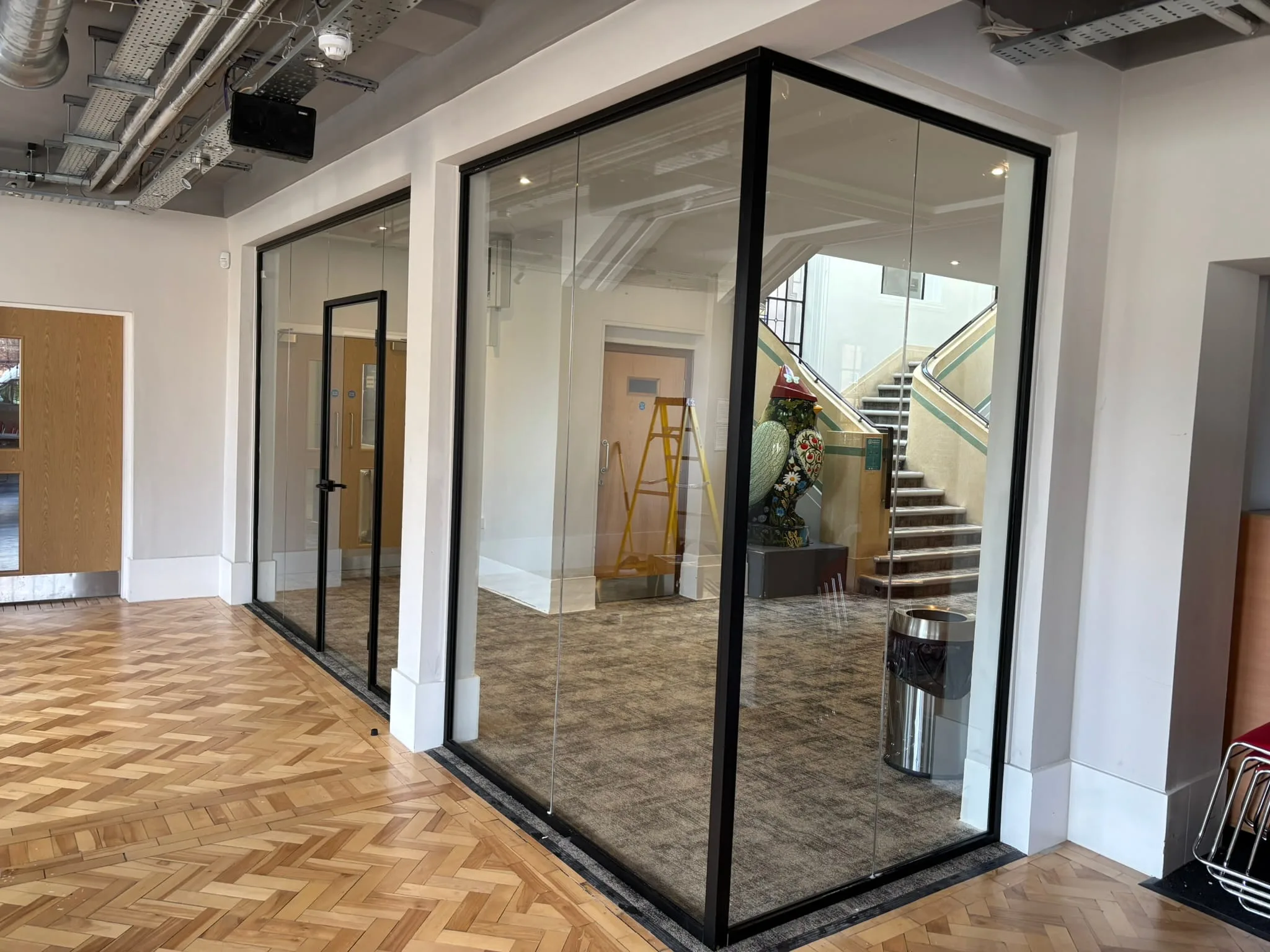 Black aluminium framed glass partition system UK commercial interior