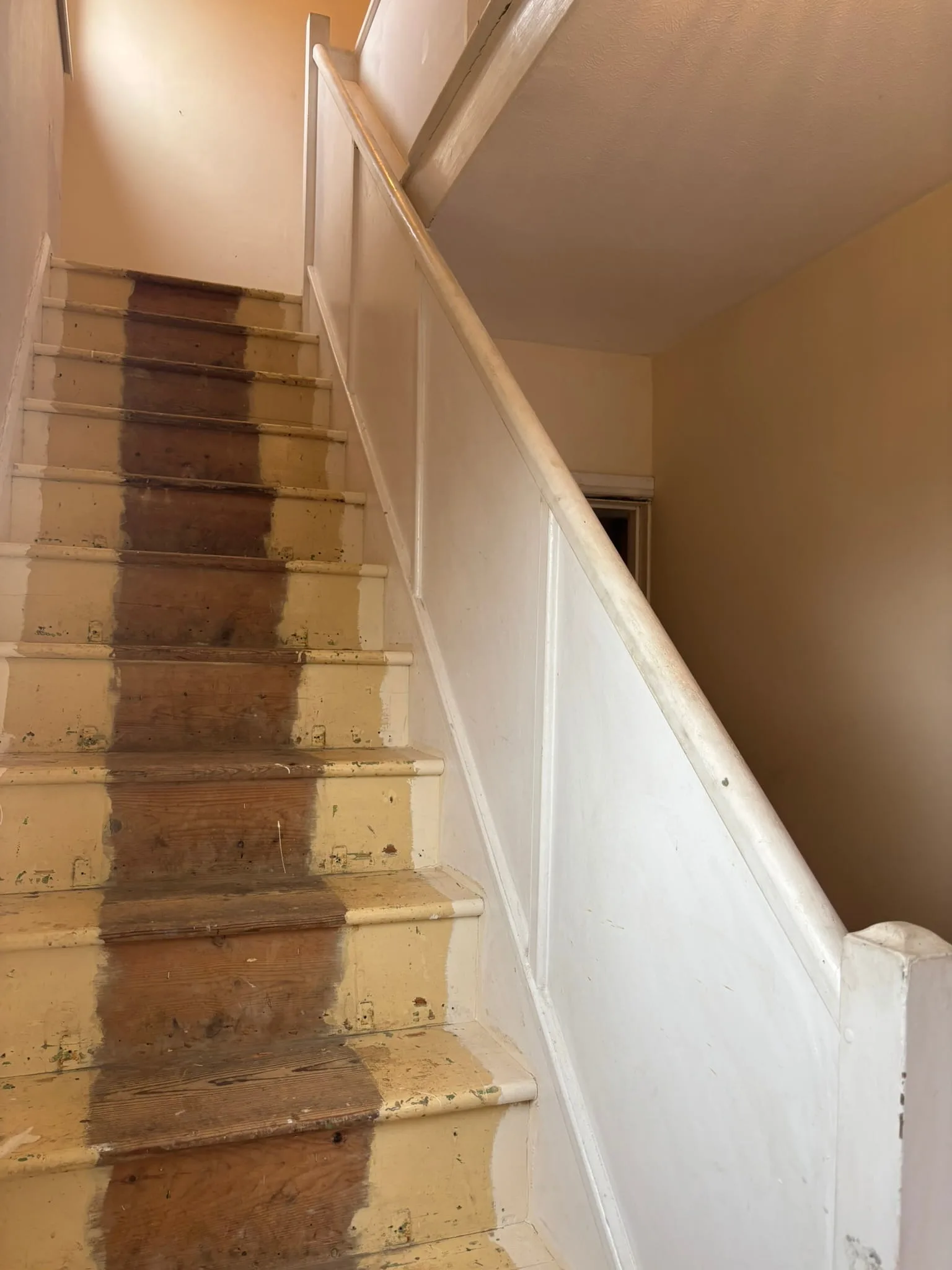 Before and after staircase upgrade from spindles to glass