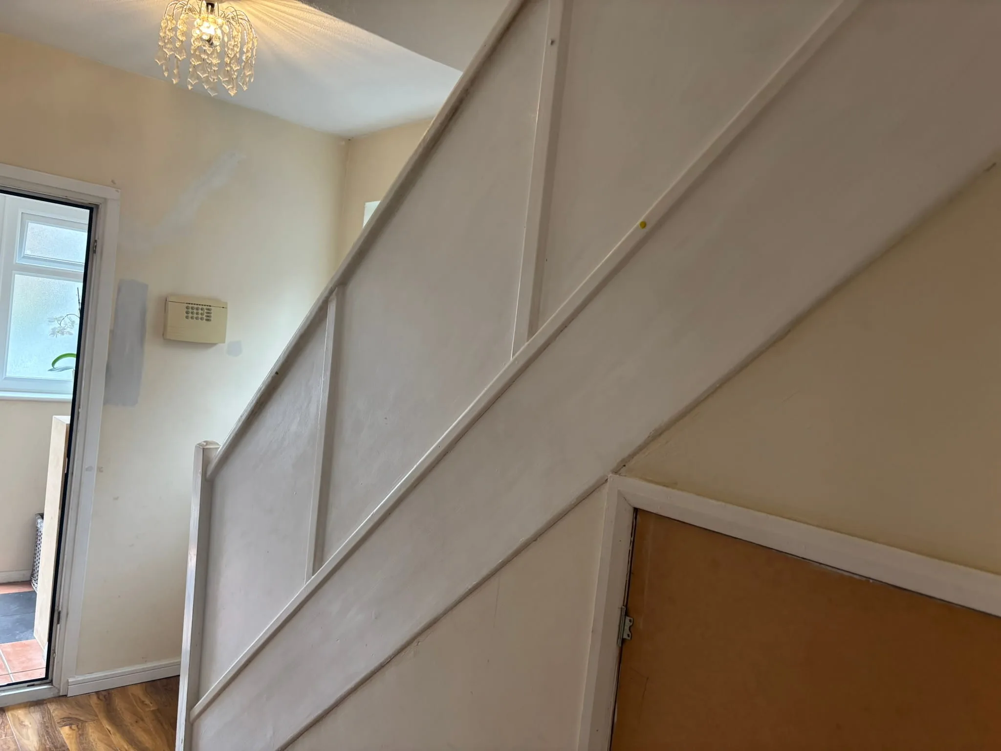 Internal staircase with clean glass balustrade and oak finish