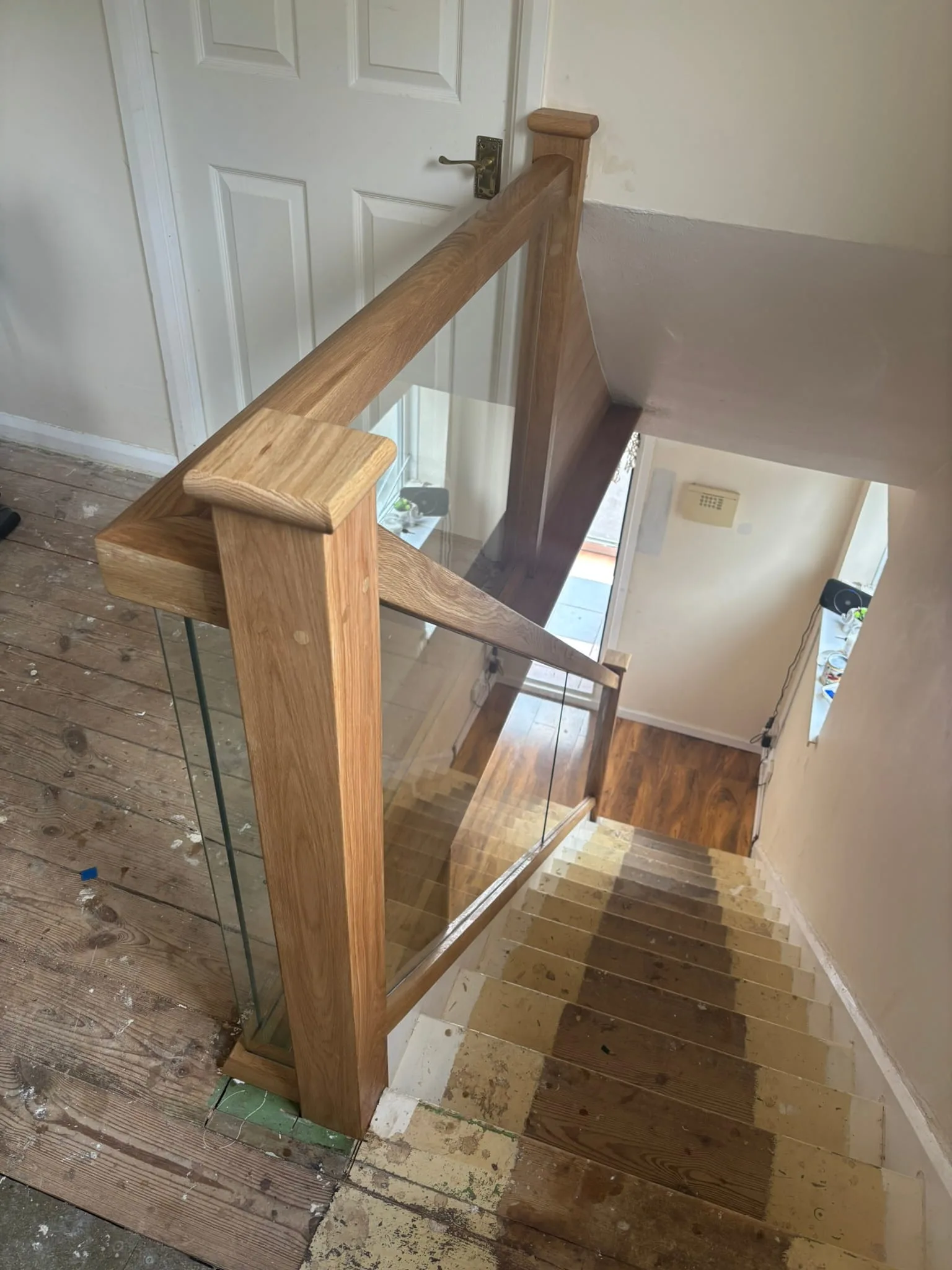 Glass panels bonded into oak grooves for seamless look