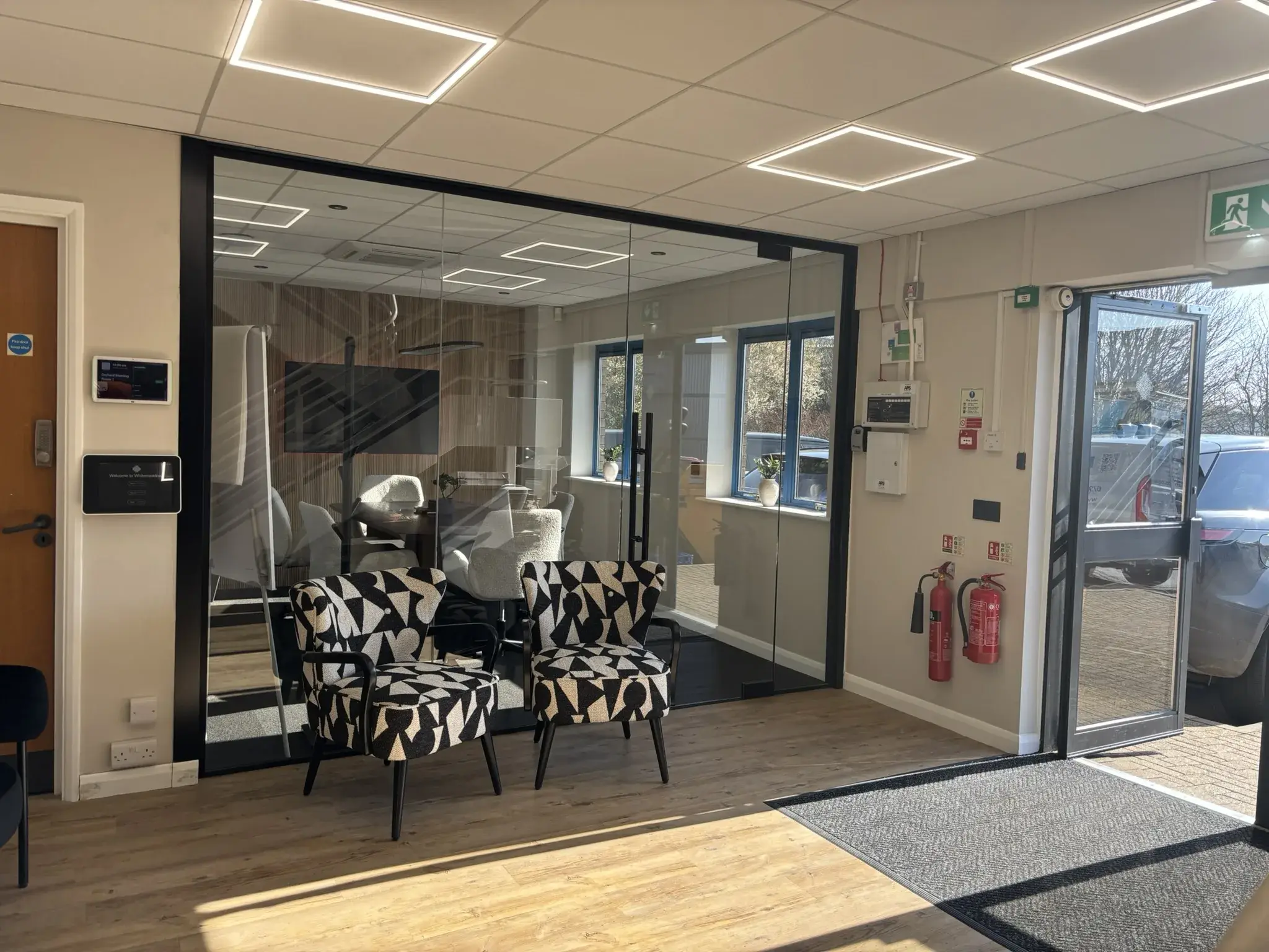 Modern glass partition wall installed in meeting room at upholstery company