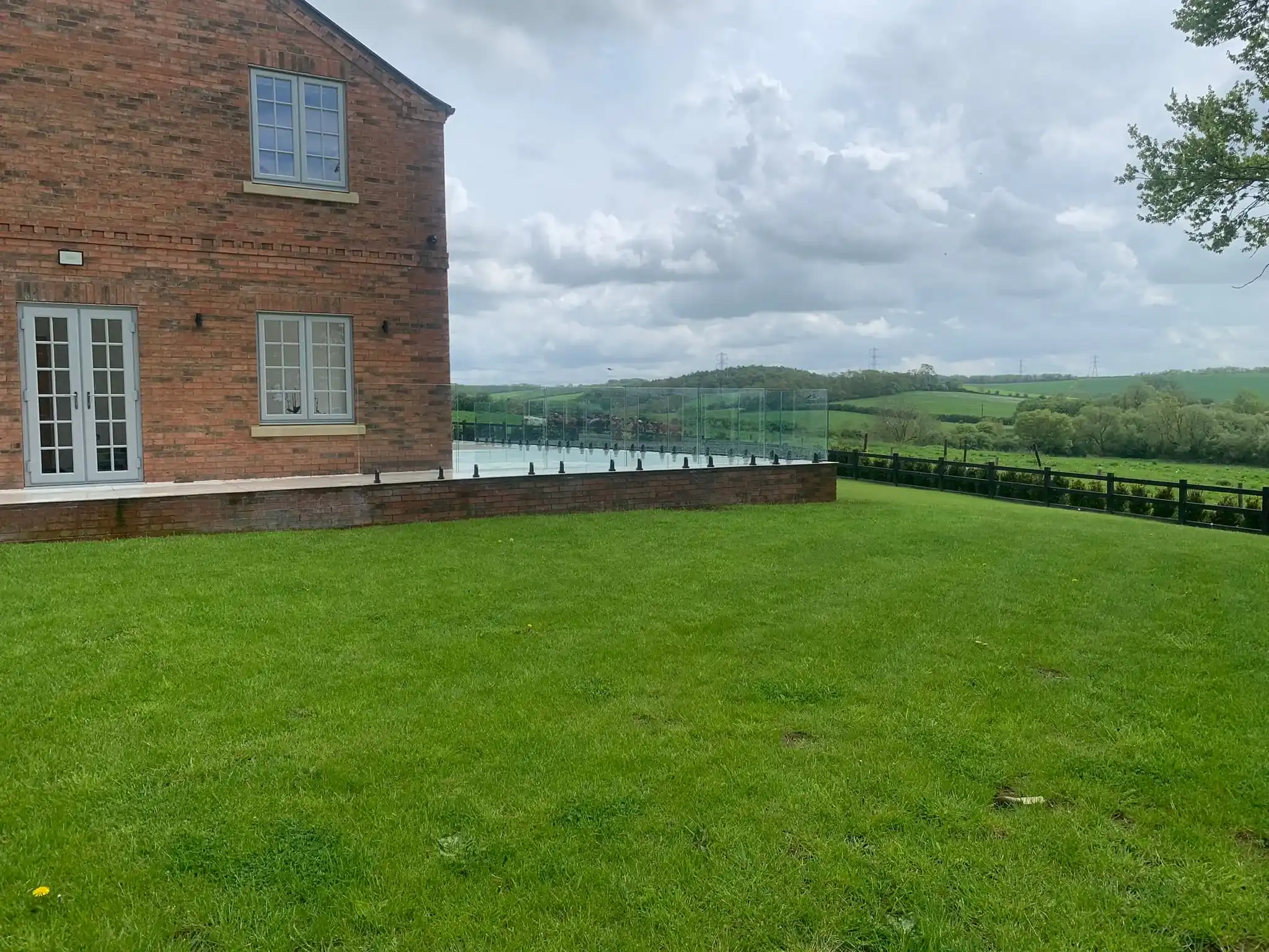 Outdoor terrace glass balustrade with minimal visible hardware