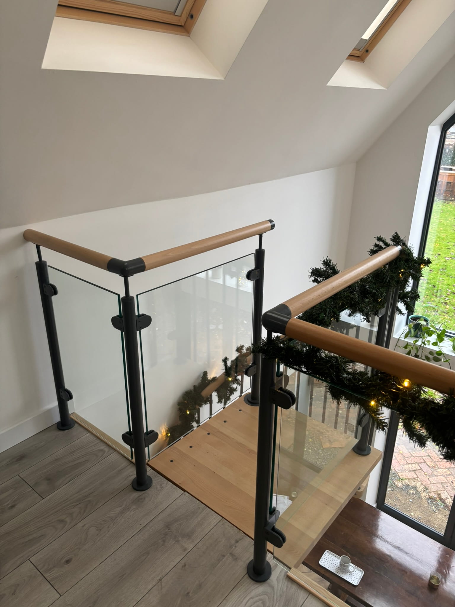 10mm toughened glass balustrade panels between basalt grey steel posts in stairwell, Bingham
