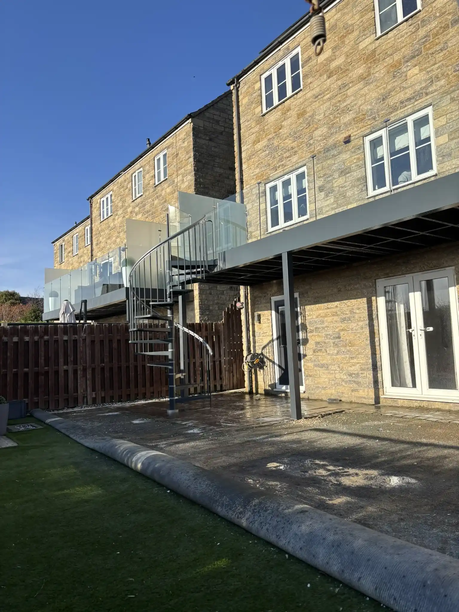 External steel balcony spanning full width of property